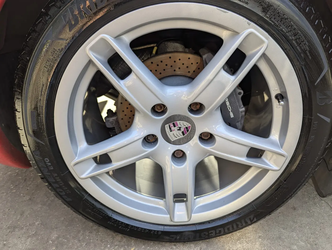 Refurbished Porsche alloy wheel in silver at WK Detailing, Stratford-upon-Avon